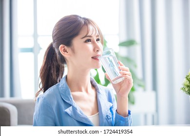 Asian Woman Drink Water And Feel Good At Home