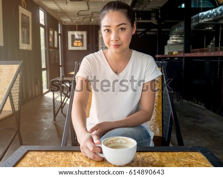 Asian woman drinking coffee in the cafe in the morning.