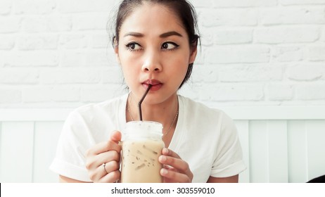 Asian Woman Drinking Ice Coffee