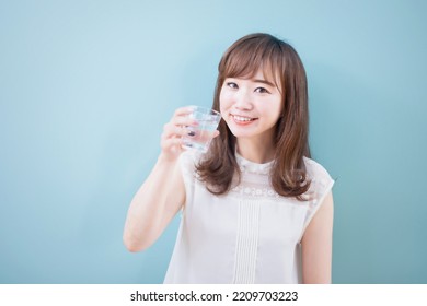 Asian Woman Drinking Mineral Water