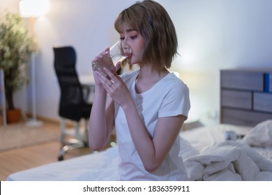 Asian Woman Drinking Water Before Going To Bed At Night