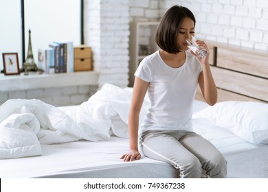 Asian Woman Drinks Water After Waking Up In The Morning.