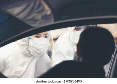 Asian Woman Drive Thru Covid-19 Testing With PPE Medical Staff, COVID Testing Temp While Checking In Cars