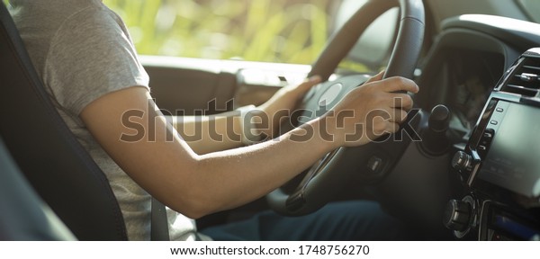 Asian\
woman driver driving off road car in the\
nature