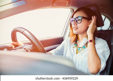 Asian Woman Driving A Car