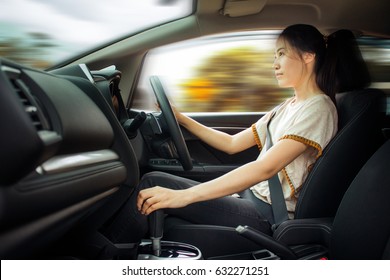 Asian Woman Driving A Car