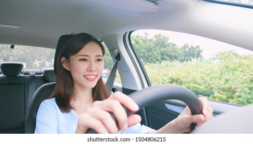 Asian Woman Driving Happily In The Car