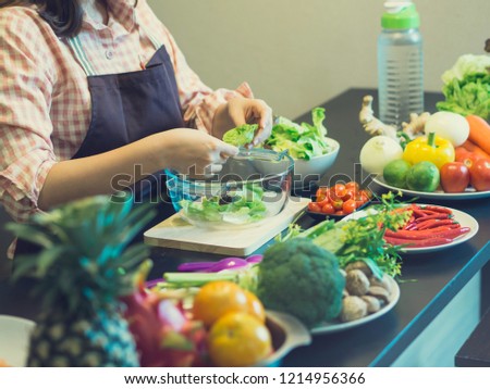 Asian woman during make salad clean food with many fresh vegetable for good health