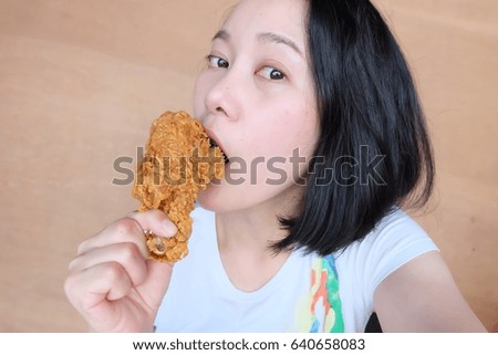 Asian woman eat Fried chicken