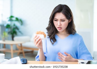 Asian Woman Eat Hamburger And Has Gastroesophageal Reflux Disease