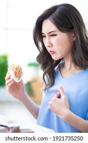 Asian Woman Eat Hamburger And Has Gastroesophageal Reflux Disease