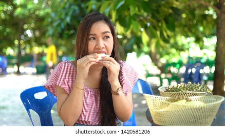 Asian Woman Eating Durian In Farm