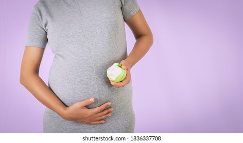 Asian Woman Eating Guava With Happy Mood.Focus On Hand