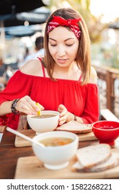 Asian Woman Eating Hot Vegetarian Soup In Cafe. Healthy Diet And Dinner Concept