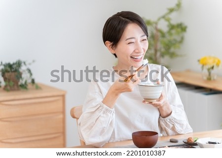 Asian woman eating a meal