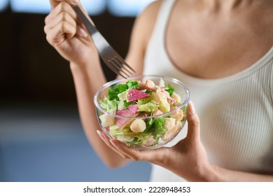 Asian woman eating salad for diet - Shutterstock ID 2228948453