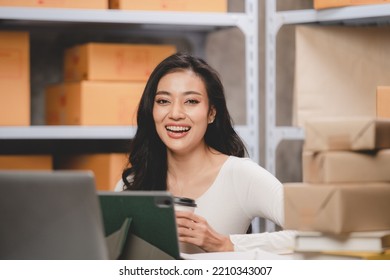Asian woman e-business entrepreneur checking order and packing parcel box of product shipping delivery business, freelance marketing owner having online cyberspace to work with logistic package job - Shutterstock ID 2210343007