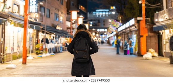Asian woman enjoy outdoor lifestyle travel at Sensoji Temple and  Asakusa district in Tokyo, Japan at night. People tourist travel Japan landmark famous place walking city street on holiday vacation. - Powered by Shutterstock