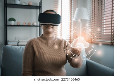 Asian woman enjoy using AI technology in VR glasses to explore the Metaverse or online digital access. Smart technology of VR virtual realty can make the world on hand. - Shutterstock ID 2273456465