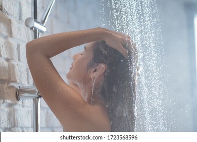 Asian Woman Enjoying The Shower She Is Washing Her Hair.