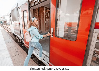Asian woman entering wagon of a train. Railway transport concept