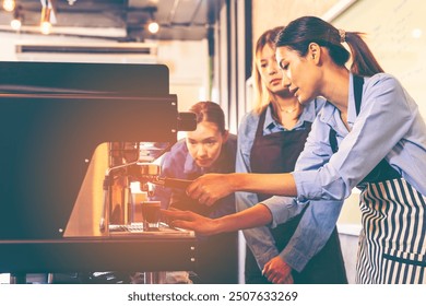 Asian woman entrepreneur making coffee from machine while standing by coworker at cafe. Female barista making coffee in coffee shop counter. Takeaway food. Professional coffee making. Small business. - Powered by Shutterstock