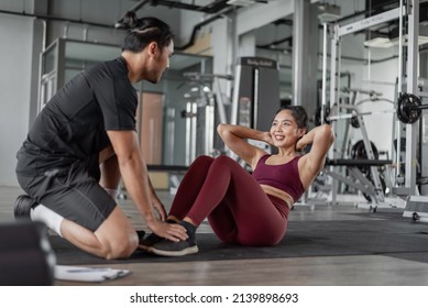 Asian woman exercise with personal trainer in gym. Healthy woman doing abs workout in fitness with personal coach. - Powered by Shutterstock