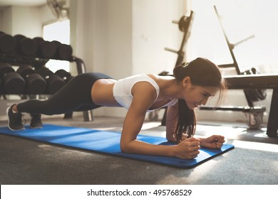 Asian woman exercising in the gym, she was pretending to "plank"