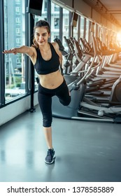Asian woman exercising in the gym, Young woman workout in fitness for her healthy and office girl lifestyle. She using smart phone to check an email or listening music. - Shutterstock ID 1378585889