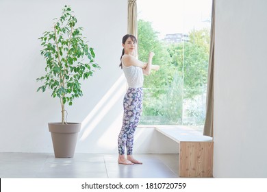 Asian Woman Exercising At Home