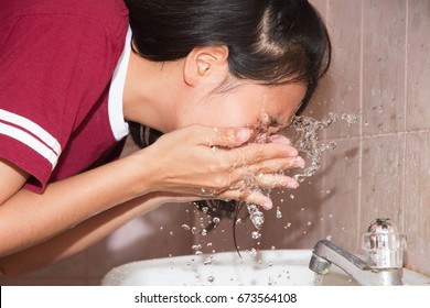 Asian Woman Face Wash At Basin