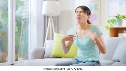 Asian Woman Feel Hot And Sweaty Use Hand Fanned To Cool Down In Summer Sit On Sofa At Home