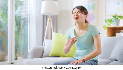 Asian Woman Feel Hot And Sweaty Use Hand Fanned To Cool Down In Summer Sit On Sofa At Home