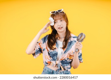 Asian Woman Feeling Hot During Summer Wiping Her Forehead - Powered by Shutterstock