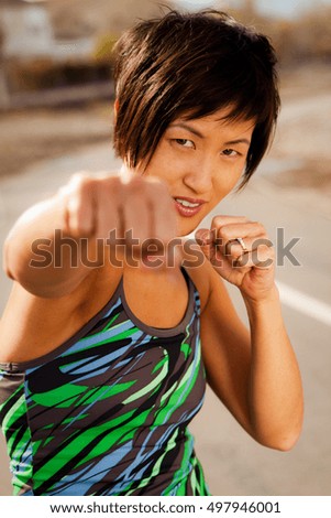 Asian woman feeling strong and confident after a workout. 