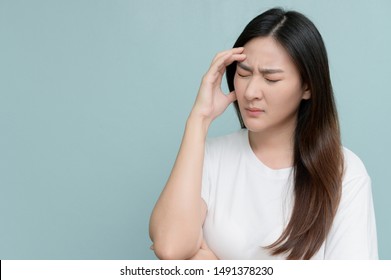 Asian Woman Feeling Unwell Suffering From Headache Migraine Touching Forehead And Discomfort Headache Before Menstruation.