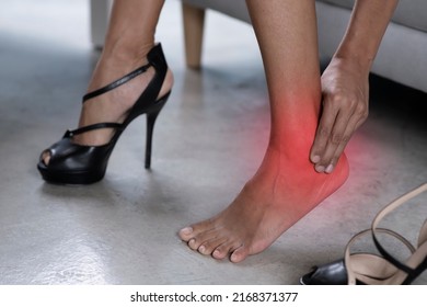 Asian Woman Feet Pain Wear High Heel Shoes. Young Woman Feeling Ache Because Of Wearing High Heels In Office. Female With Sore Feet Taking Off High Heels At Home