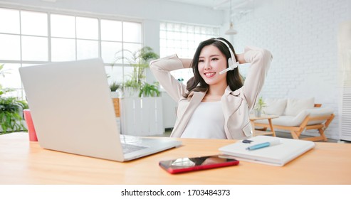 Asian woman finish a successful video meeting and she use computer to telework  at home