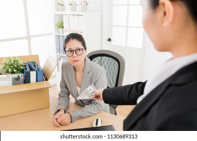 Asian woman is fired and her boss gave her some severance payment. She is unwilling to leave.