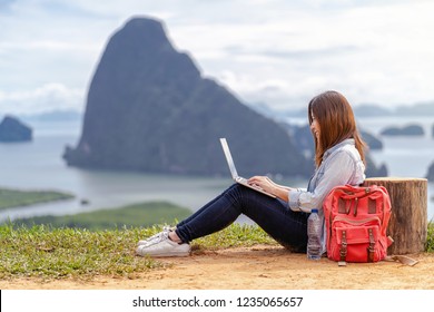 Asian woman freelancer working with technology laptop with happiness action at Fantastic Landscape of samed nang chee view point, Freelance working and travel anywhere concept