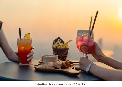 Asian woman friends celebrating dinner party together at skyscraper rooftop restaurant bar in the city at summer sunset. Attractive girl enjoy urban outdoor lifestyle nightlife on holiday vacation. - Powered by Shutterstock