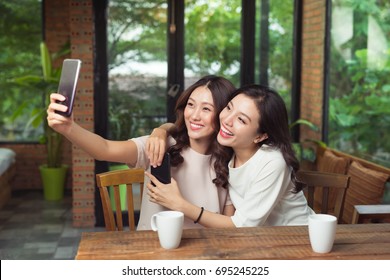 Asian Woman Friends Hugging And Make Selfie Photo Together