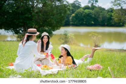  Asian Woman Friends. They Are Having A Picnic, Eating In The Morning