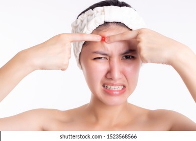 Asian Woman Get Acne Inflammatory, Popping Pimple On Forehead, Beautiful Face. Pretty Girl Get Hurt, Unhappy. Acne Occur From Stress Of Work Or When Woman Get Wink Of Sleep, Acne Will Appear On Face