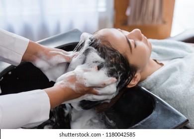 Asian Woman Getting Her Hair Washed In Beauty Salon