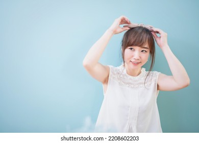 Asian Woman Getting Her Hair Done