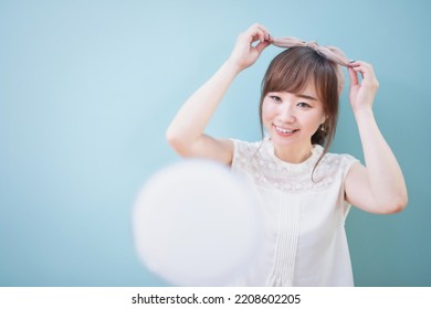 Asian Woman Getting Her Hair Done