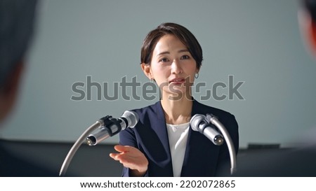 Asian woman giving a press conference