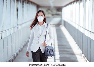 Asian woman are going to work.she wears N95 mask.prevent PM2.5 dust and smog
