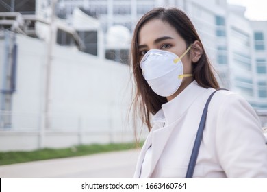 Asian Woman Are Going To Work.she Wears N95 Mask.prevent PM2.5 Smog And Virus